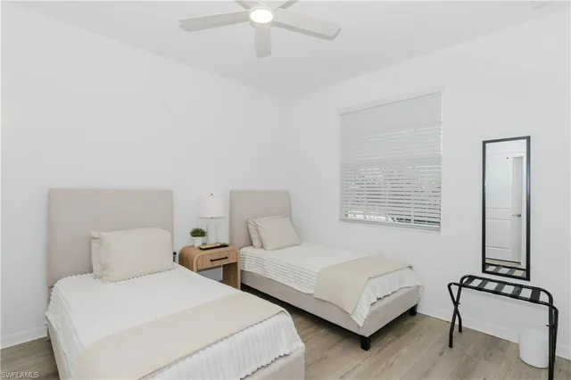 a bedroom with two beds and a window