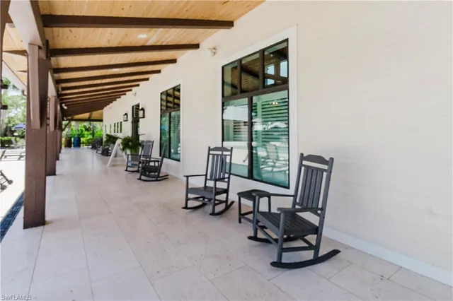 a view of a house with swimming pool and sitting area