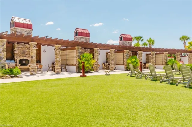 a view of swimming pool with outdoor seating and lake