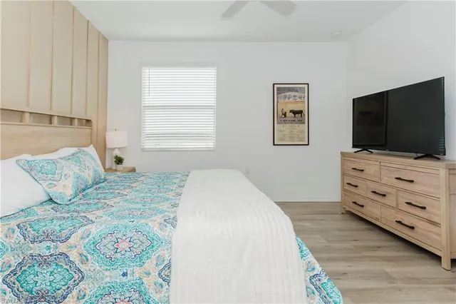 a bedroom with a bed and a flat screen tv