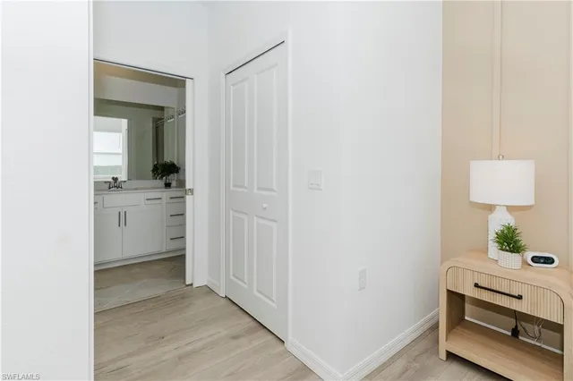 a view of a room that has a sink and a mirror in it