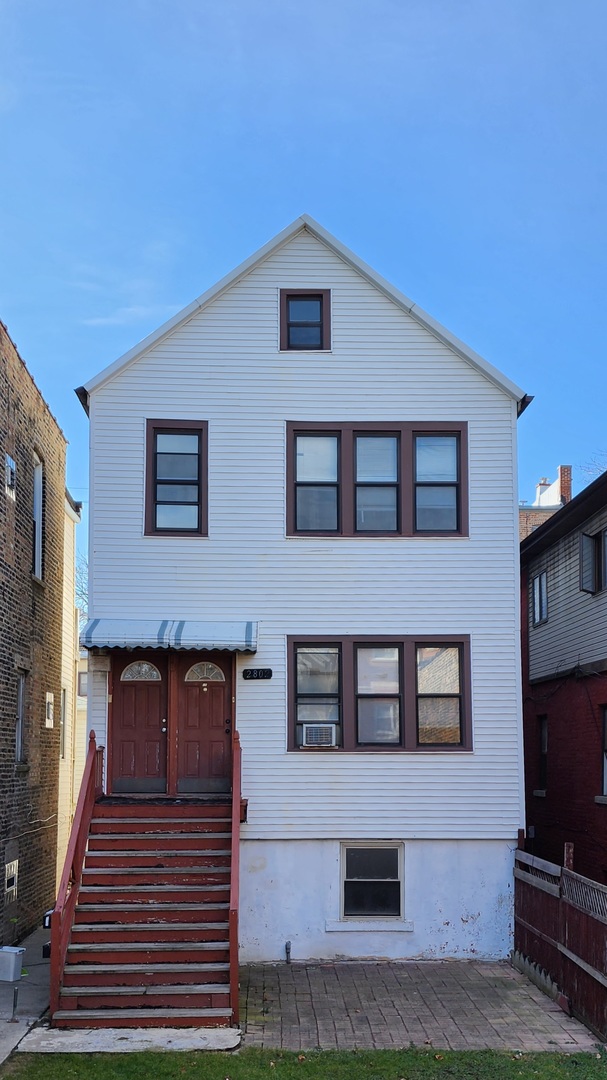 2802 South Lowe Avenue, Unit G Chicago, IL 60616 - Photo 1 of 11 a front view of a house with a yard