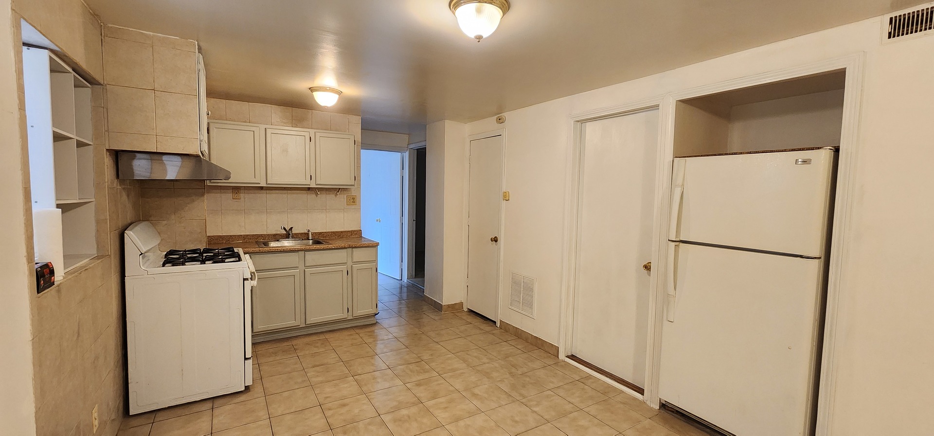 2802 South Lowe Avenue, Unit G Chicago, IL 60616 - Photo 6 of 11 a kitchen with stainless steel appliances a refrigerator and a stove top oven