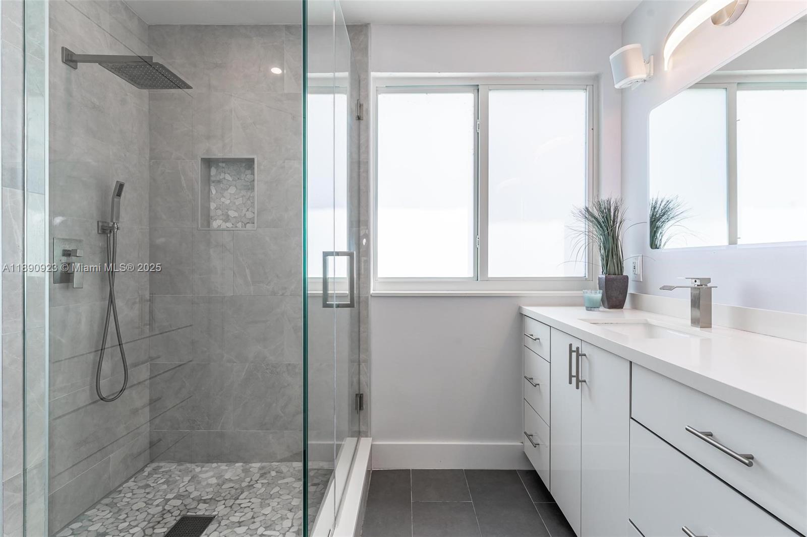 925 Briar Ridge Road Weston, FL 33327 - Photo 13 of 30 a bathroom with a shower sink and vanity