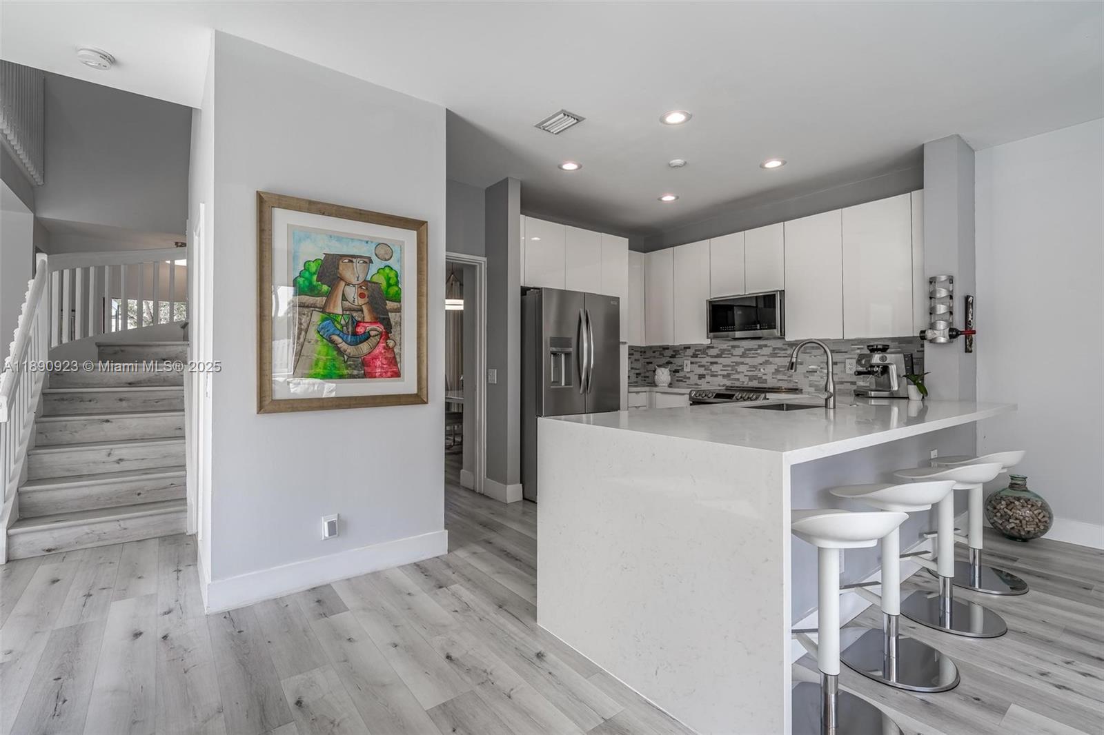 925 Briar Ridge Road Weston, FL 33327 - Photo 19 of 30 a kitchen with stainless steel appliances a refrigerator sink and microwave