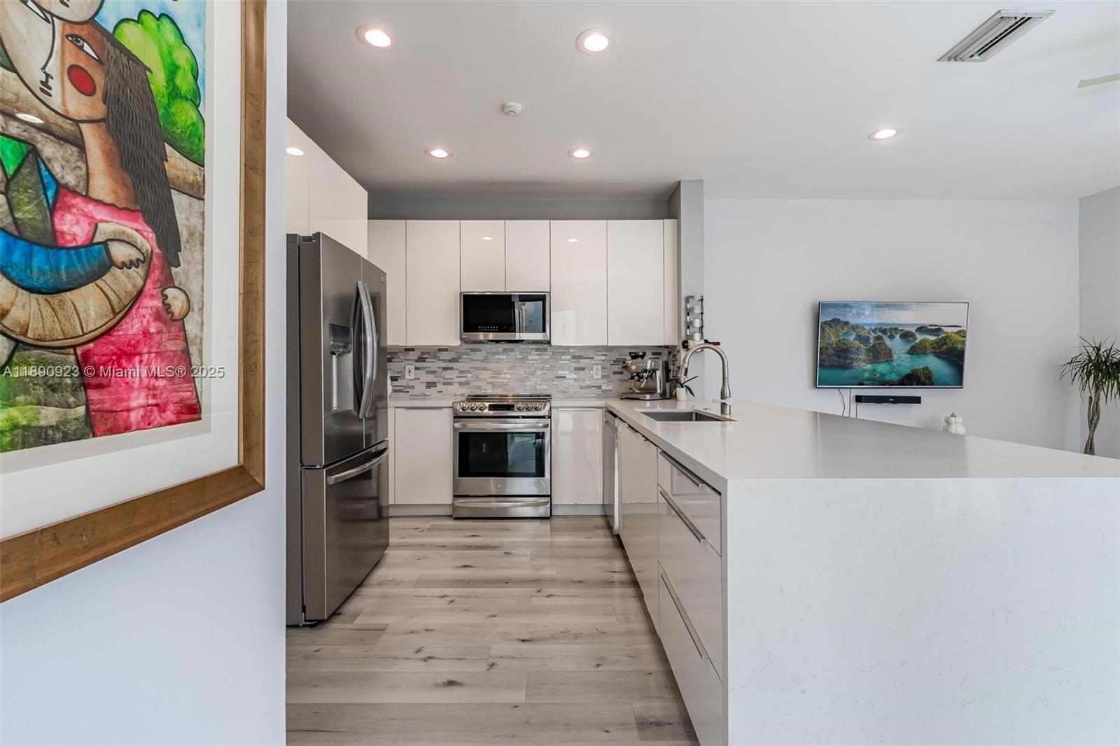 925 Briar Ridge Road Weston, FL 33327 - Photo 21 of 30 a kitchen with stainless steel appliances a stove refrigerator and microwave