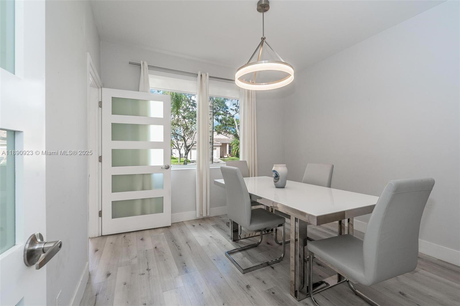 925 Briar Ridge Road Weston, FL 33327 - Photo 23 of 30 a view of a dining room with furniture window and wooden floor
