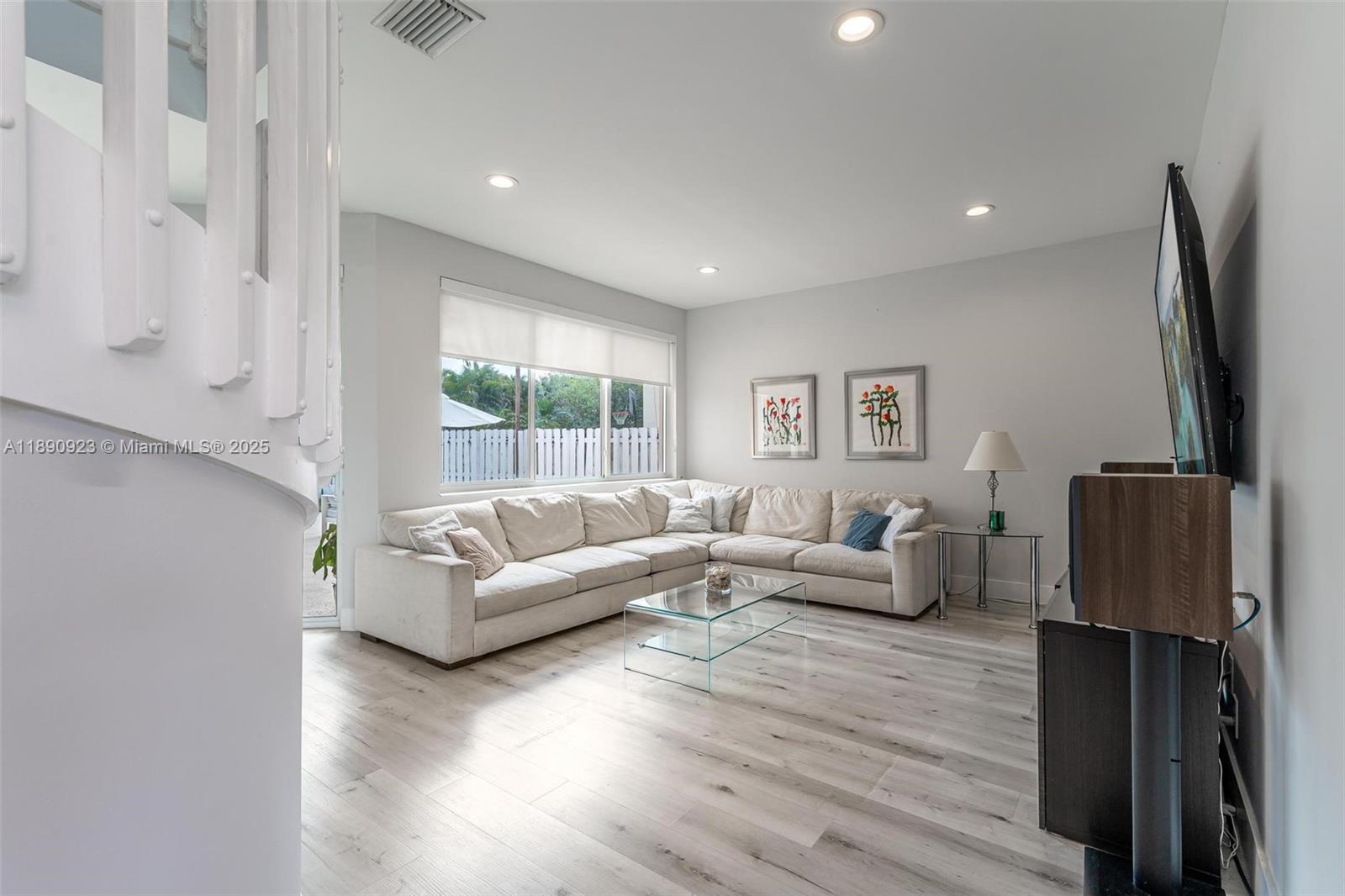 925 Briar Ridge Road Weston, FL 33327 - Photo 25 of 30 a living room with furniture a wooden floor and a flat screen tv