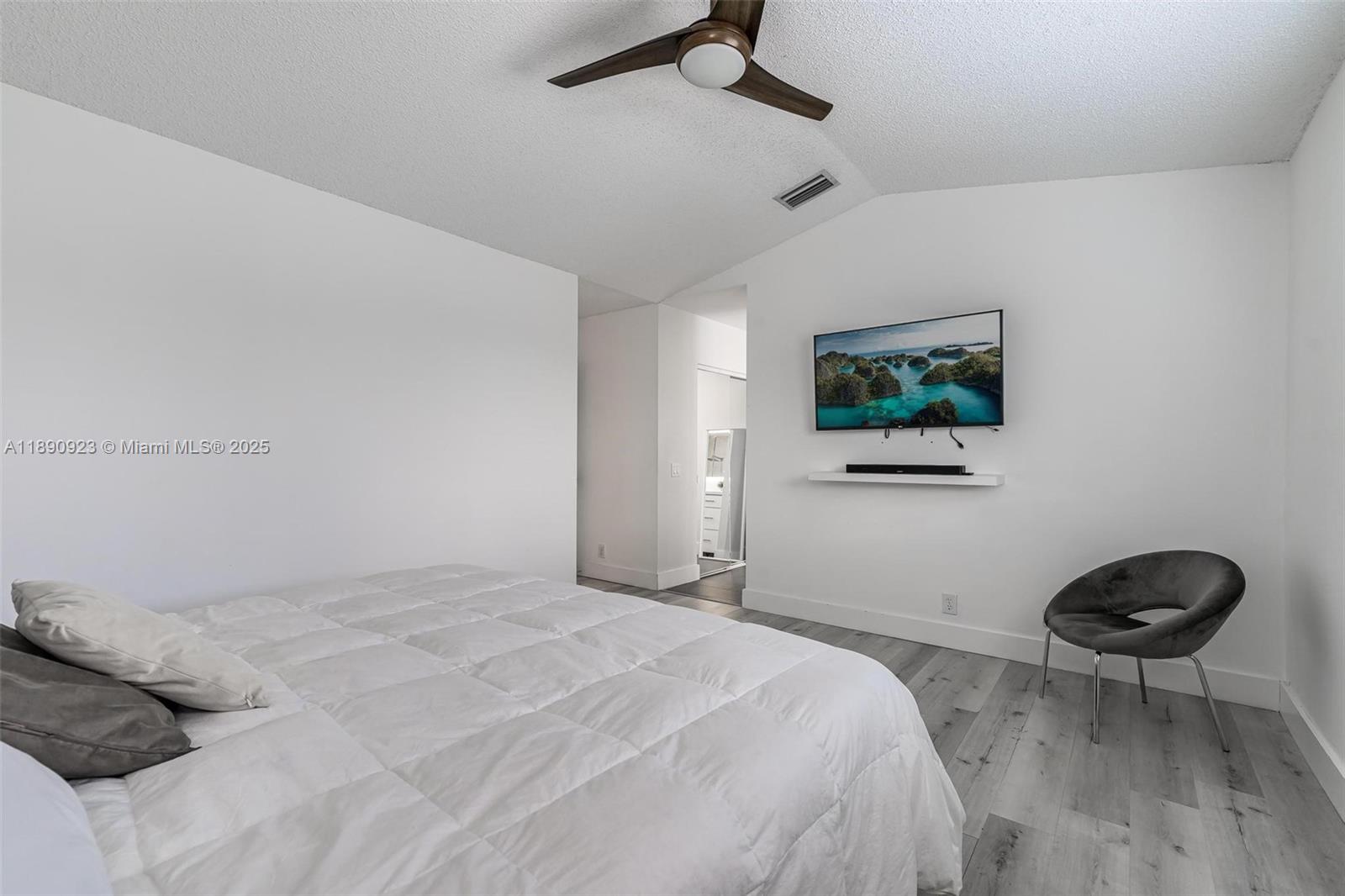925 Briar Ridge Road Weston, FL 33327 - Photo 7 of 30 a bedroom with a bed and a chair
