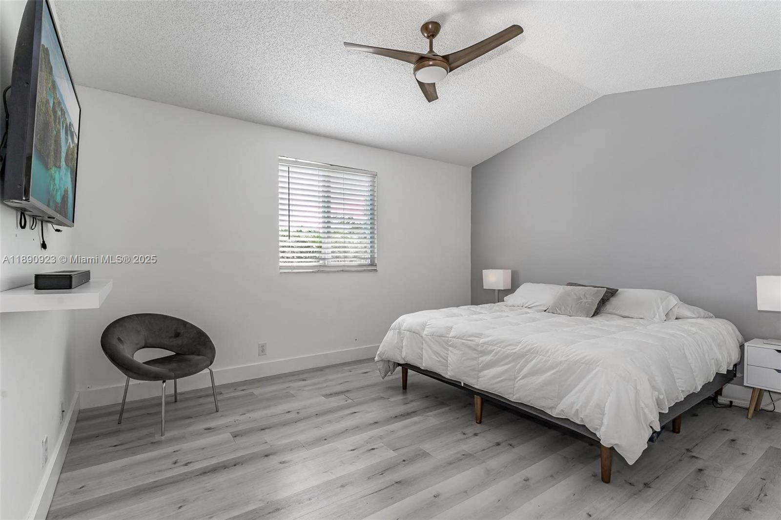 925 Briar Ridge Road Weston, FL 33327 - Photo 8 of 30 a bedroom with a bed a mirror and a window