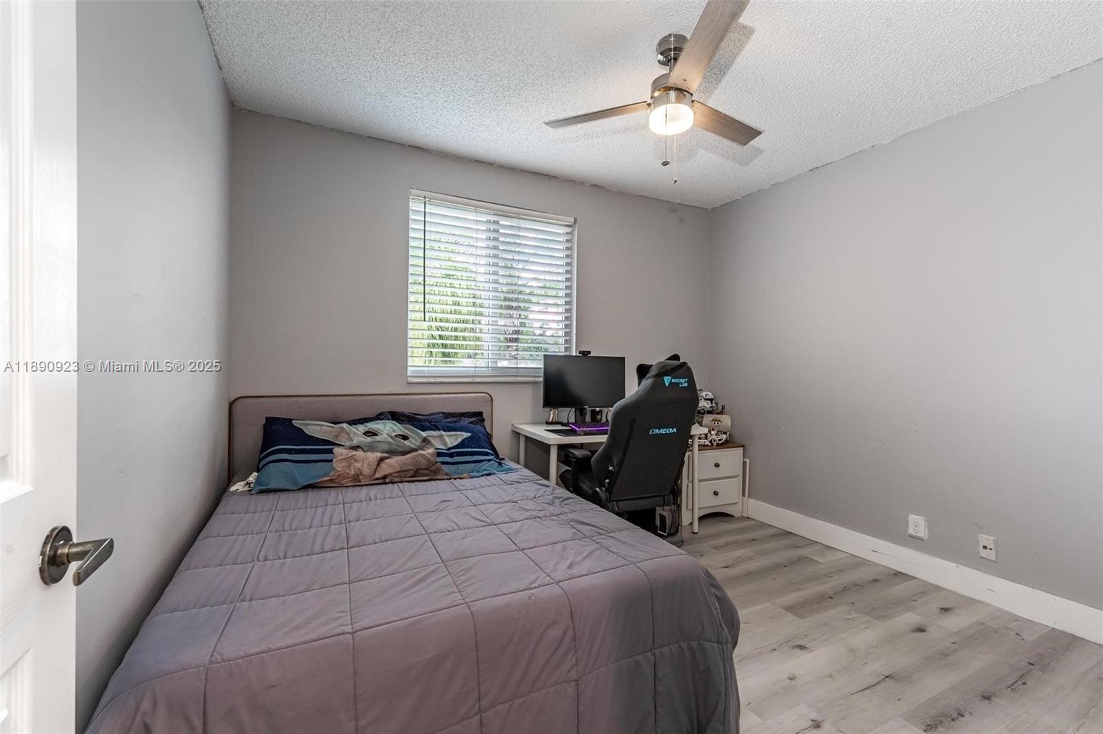 925 Briar Ridge Road Weston, FL 33327 - Photo 9 of 30 a bedroom with a bed and a chandelier