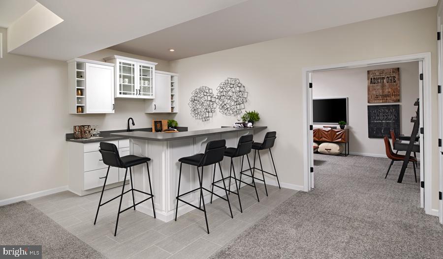 2020 St James Road Accokeek, MD 20607 - Photo 3 of 13 a dining hall with stainless steel appliances kitchen island granite countertop a table and chairs in it