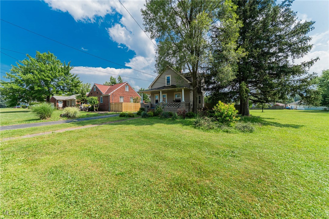 13614 Granger Road Cleveland, OH 44125 - Photo 3 of 38 View of grassy yard featuring a porch