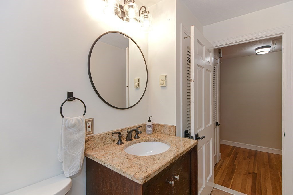 137 Howard Street Northborough, MA 01532 - Photo 18 of 41 a bathroom with a granite countertop sink and a mirror