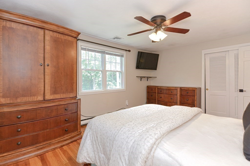 137 Howard Street Northborough, MA 01532 - Photo 21 of 41 a bedroom with a large bed and a flat tv screen