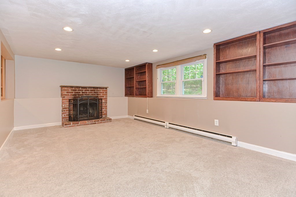 137 Howard Street Northborough, MA 01532 - Photo 28 of 41 an empty room with windows and fireplace