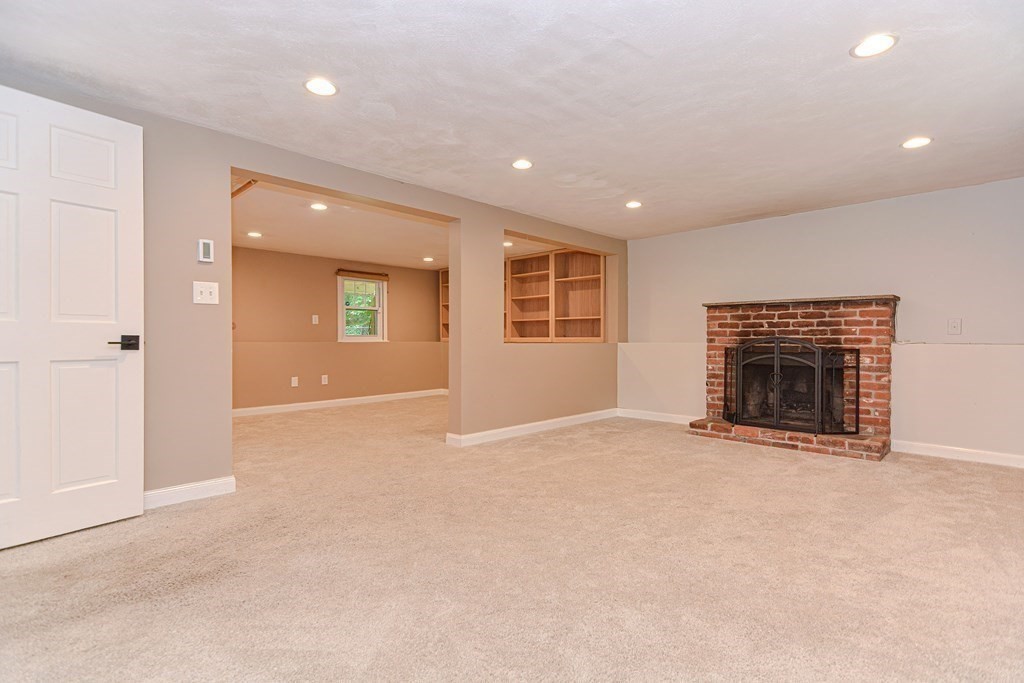 137 Howard Street Northborough, MA 01532 - Photo 29 of 41 an empty room with windows and fireplace