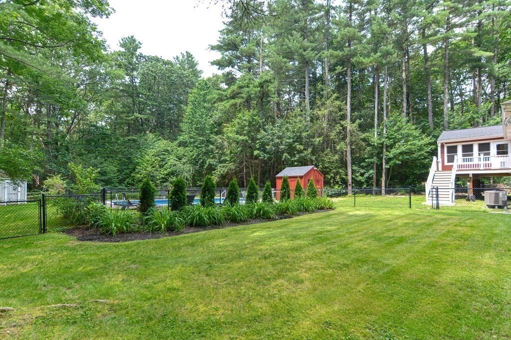 137 Howard Street Northborough, MA 01532 - Photo 34 of 41 a backyard of a house with lots of green space and fountain