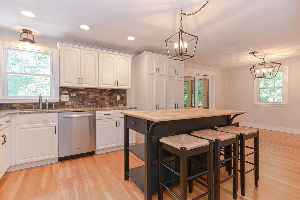 137 Howard Street Northborough, MA 01532 - Photo 9 of 41 a kitchen with a table chairs a sink dishwasher window and cabinets