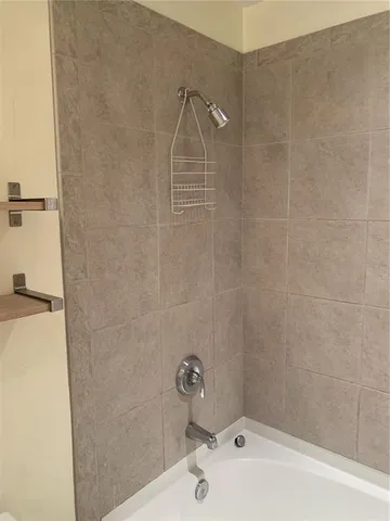 a bathroom with a white sink and a shower
