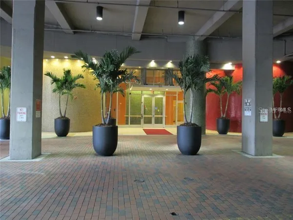 a view of a living room with chandelier and fireplace