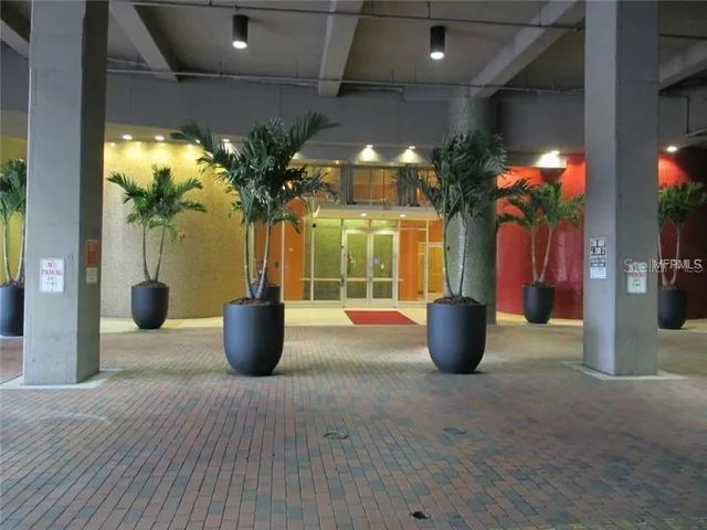 a view of a living room with chandelier and fireplace