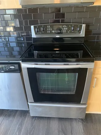 a stove top oven sitting inside of a kitchen