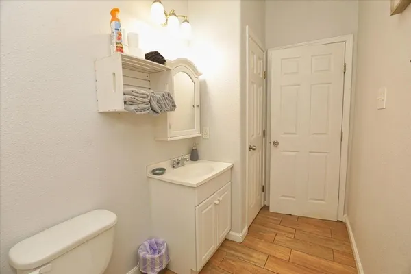 a bathroom with a toilet a sink and mirror