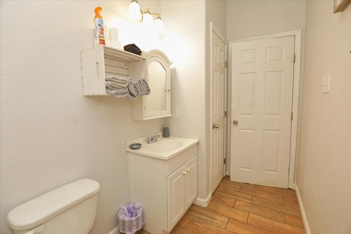 13121 Vickery Street, Unit 5 Houston, TX 77039 - Photo 18 of 40 a bathroom with a toilet a sink and mirror