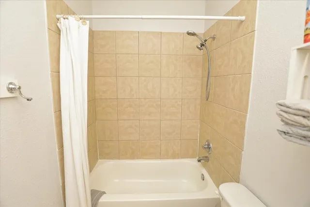 a bathroom with a shower and a bath tub