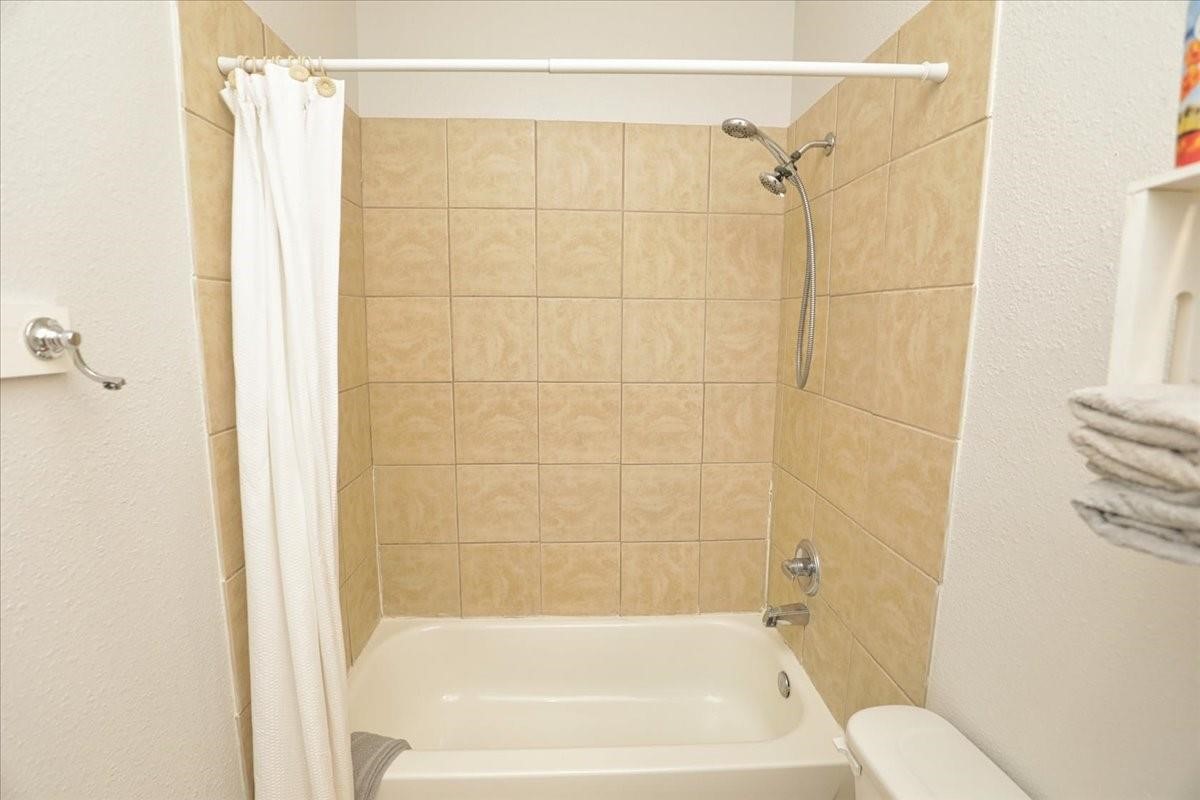 13121 Vickery Street, Unit 5 Houston, TX 77039 - Photo 20 of 40 a bathroom with a shower and a bath tub