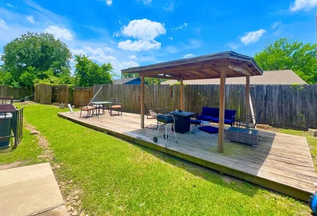 a view of a backyard with a patio