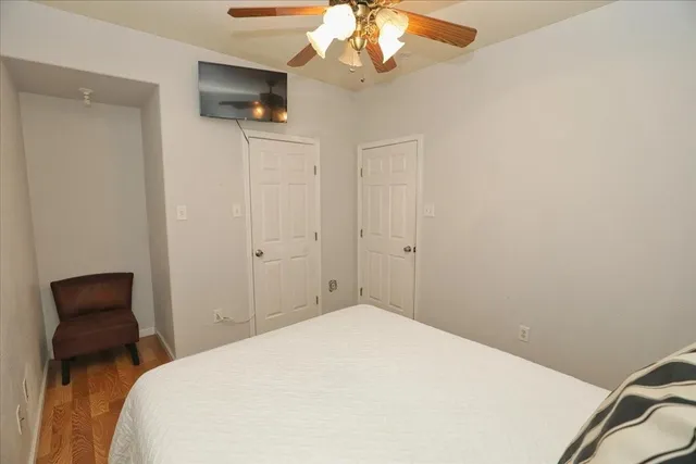 a bedroom with a bed and a chandelier