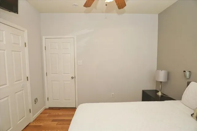 a bedroom with a bed and a lamp