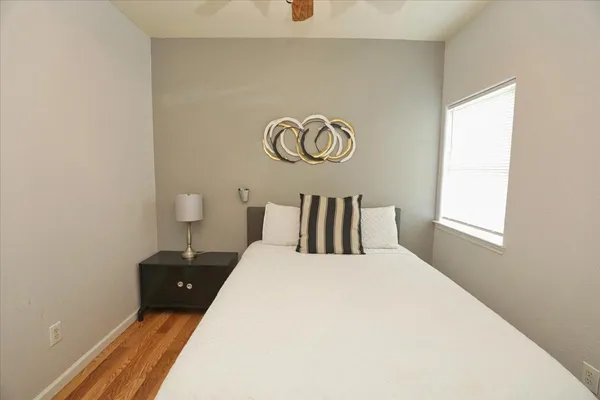 a bedroom with a bed and a window