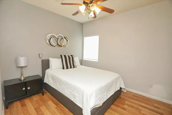 a bedroom with a bed and a chandelier