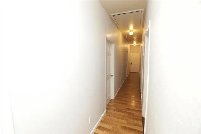 a view of a hallway with a white walls
