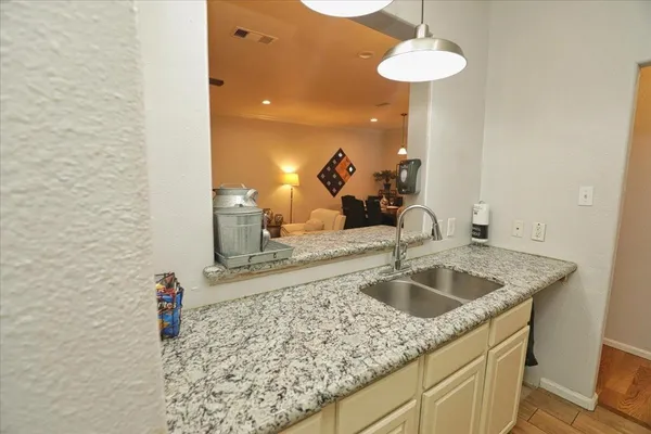 a kitchen with a sink and a chandelier