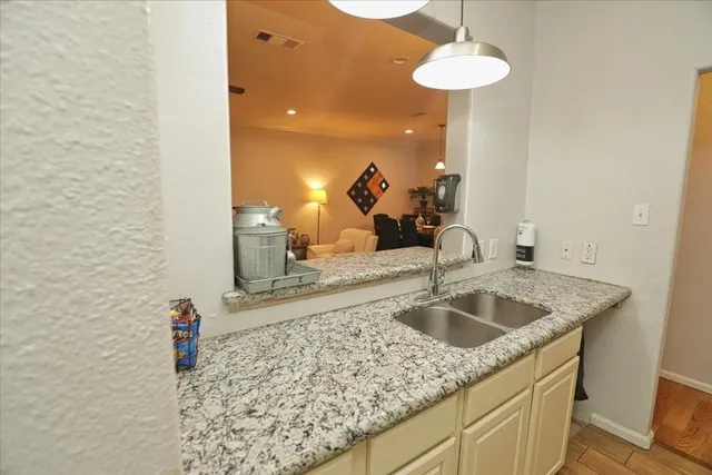 a kitchen with a sink and a chandelier