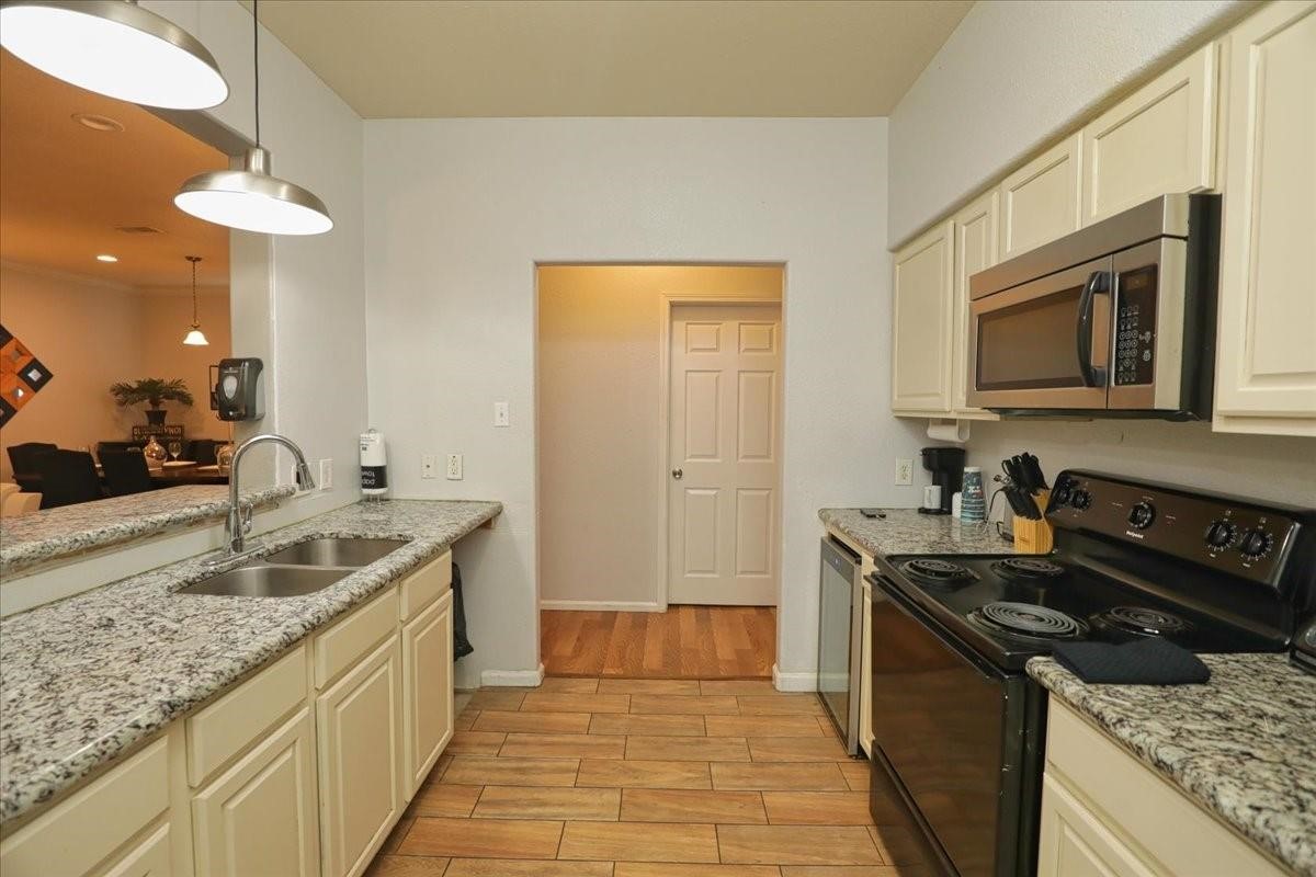 13121 Vickery Street, Unit 5 Houston, TX 77039 - Photo 31 of 40 a kitchen with a sink and a stove top oven