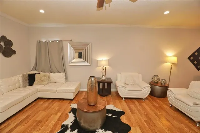a living room with furniture and a wooden floor