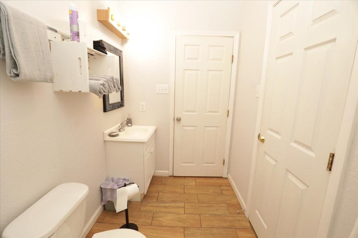 13121 Vickery Street, Unit 5 Houston, TX 77039 - Photo 5 of 40 a bathroom with a sink a toilet and shower curtain