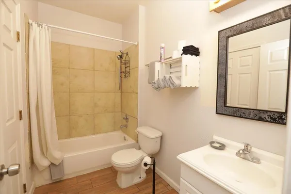 a bathroom with a sink toilet and shower
