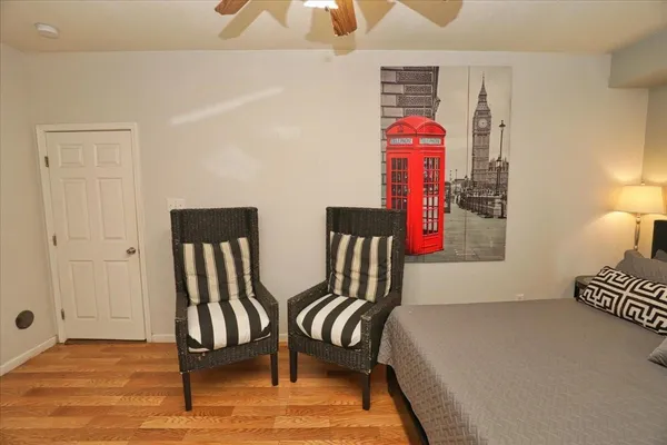 a bedroom with two beds and a lamp on table