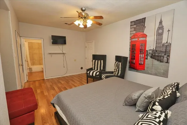 a bedroom with a bed and wooden floor