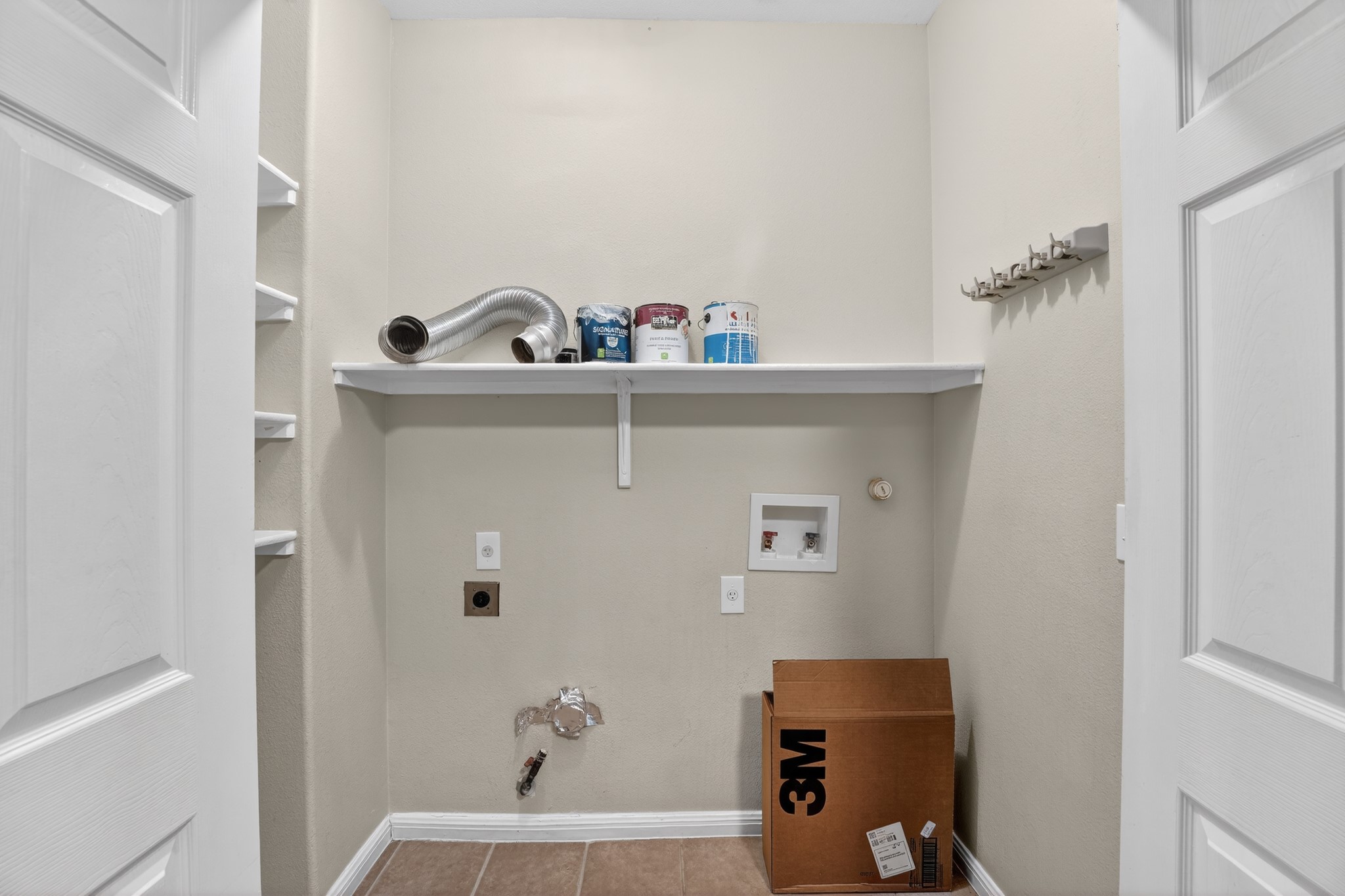 5625 Signal Point Austin, TX 78724 - Photo 28 of 33 Functional laundry space featuring convenient shelving and hookups for appliances.