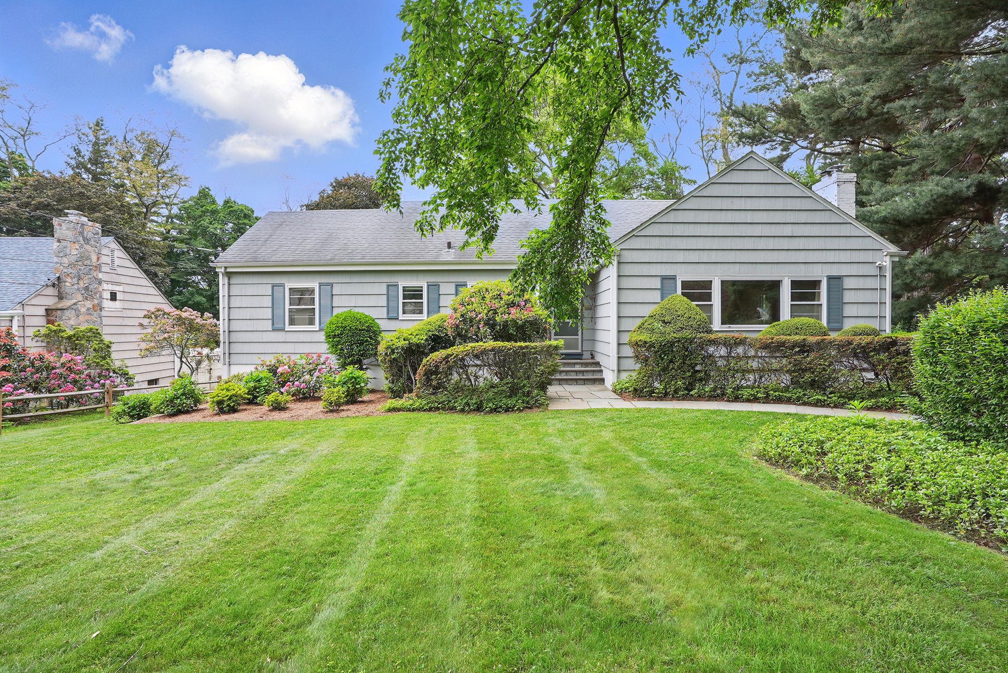 a front view of a house with a garden