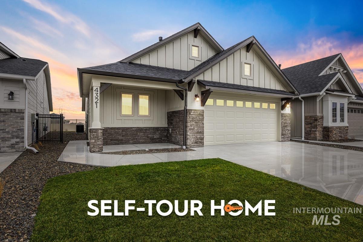 View of front of property with board and batten siding, a gate, a shingled roof, a garage, and a porch