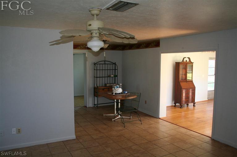 26 Maryland Road Lehigh Acres, FL 33936 - Photo 6 of 19 a view of a room with a table and chairs