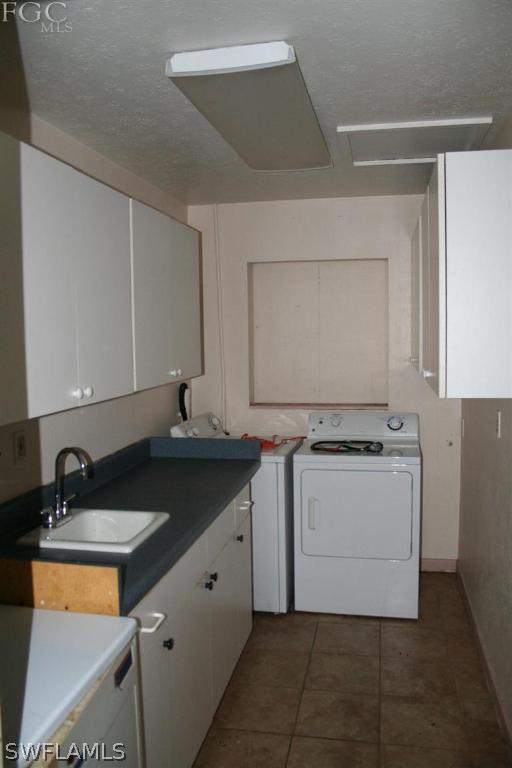 26 Maryland Road Lehigh Acres, FL 33936 - Photo 8 of 19 a utility room with cabinets washer and dryer